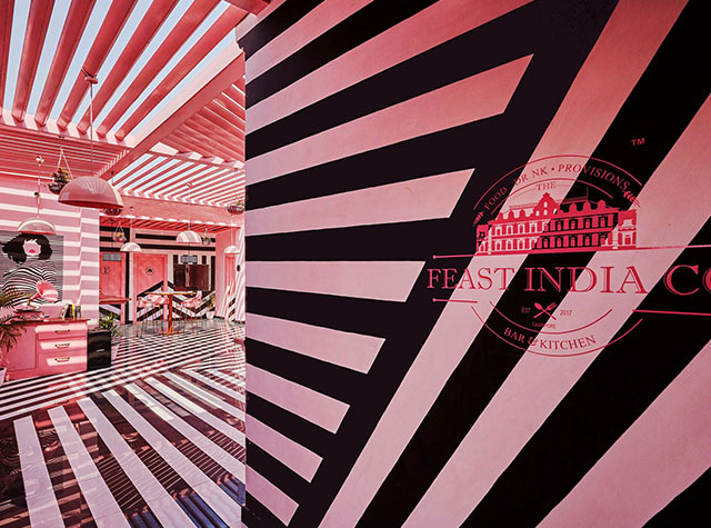 粉红色内饰和大胆斑马条纹餐厅空间设计